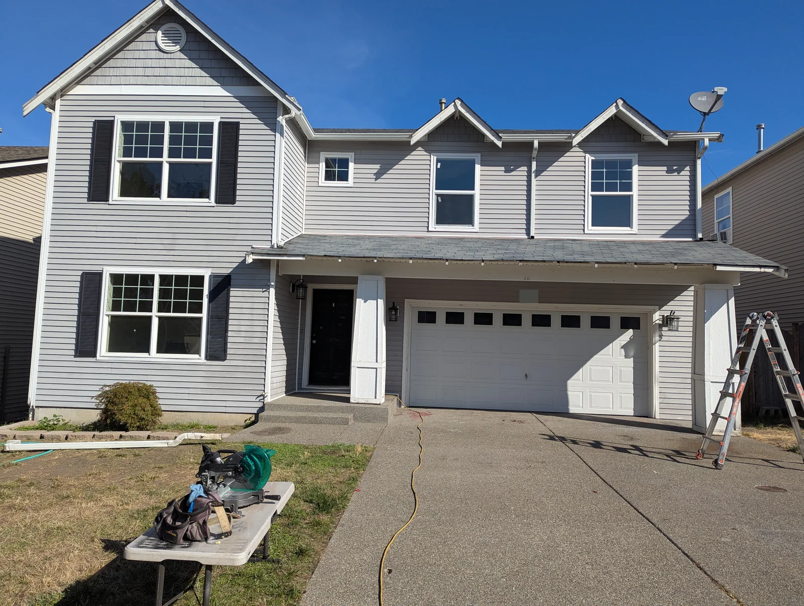 Spanaway home with old lower gutter and downspout removed